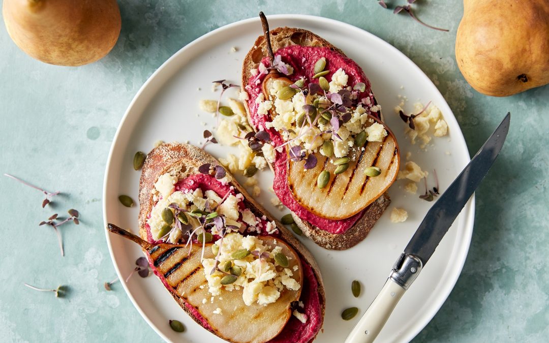 Grilled Beurré Bosc pear on beetroot hummus toast